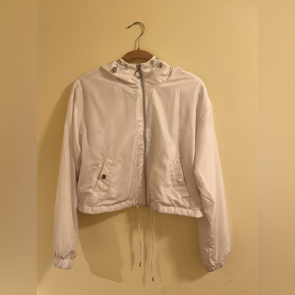 White, crop top, rain jacket.